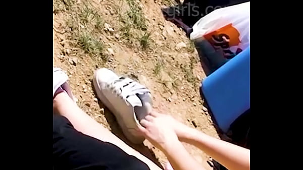 A friend slips out of her sweaty sneakers with her sweaty feet, it's very hot and in her shoes it's very hot shoe play